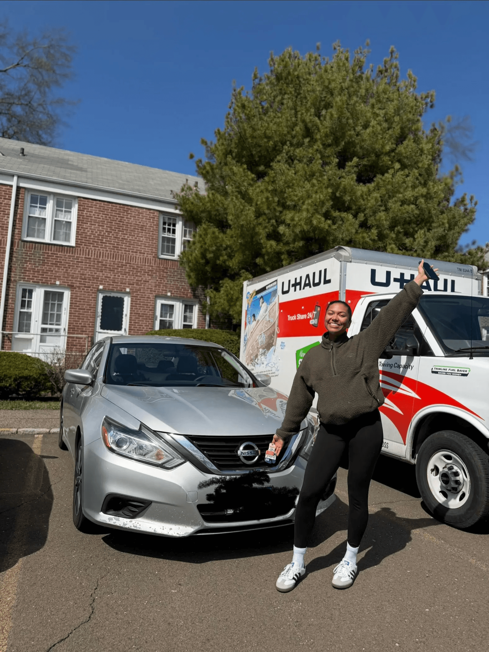 Customer standing by a moving truck after Mia's completed move